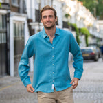 Man wearing a blue shirt made from eco -riendly hemp fabric standing on a street