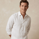 Man wearing a white hemp shirt against a beige background