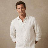 Man wearing a white hemp fabric shirt against a beige background
