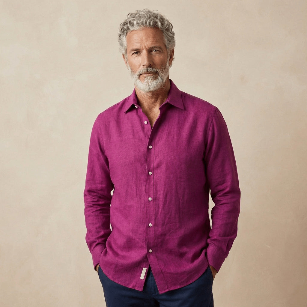 man wears a purple heavy winter shirt made from hemp fabric in front of beige coloured backdrop