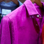 a closeup shot of a purple heavy hemp shirt on a hanger with close detail of the soft, fine fabric