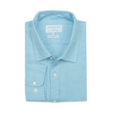 Neatly folded light blue dress shirt with a collar on a white background