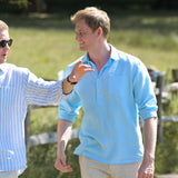 Two men walking outdoors with a blurred background. One is wearing a striped hemp shirt in sunglasses, the other is wearing a light blue hemp shirt with a chest pocket