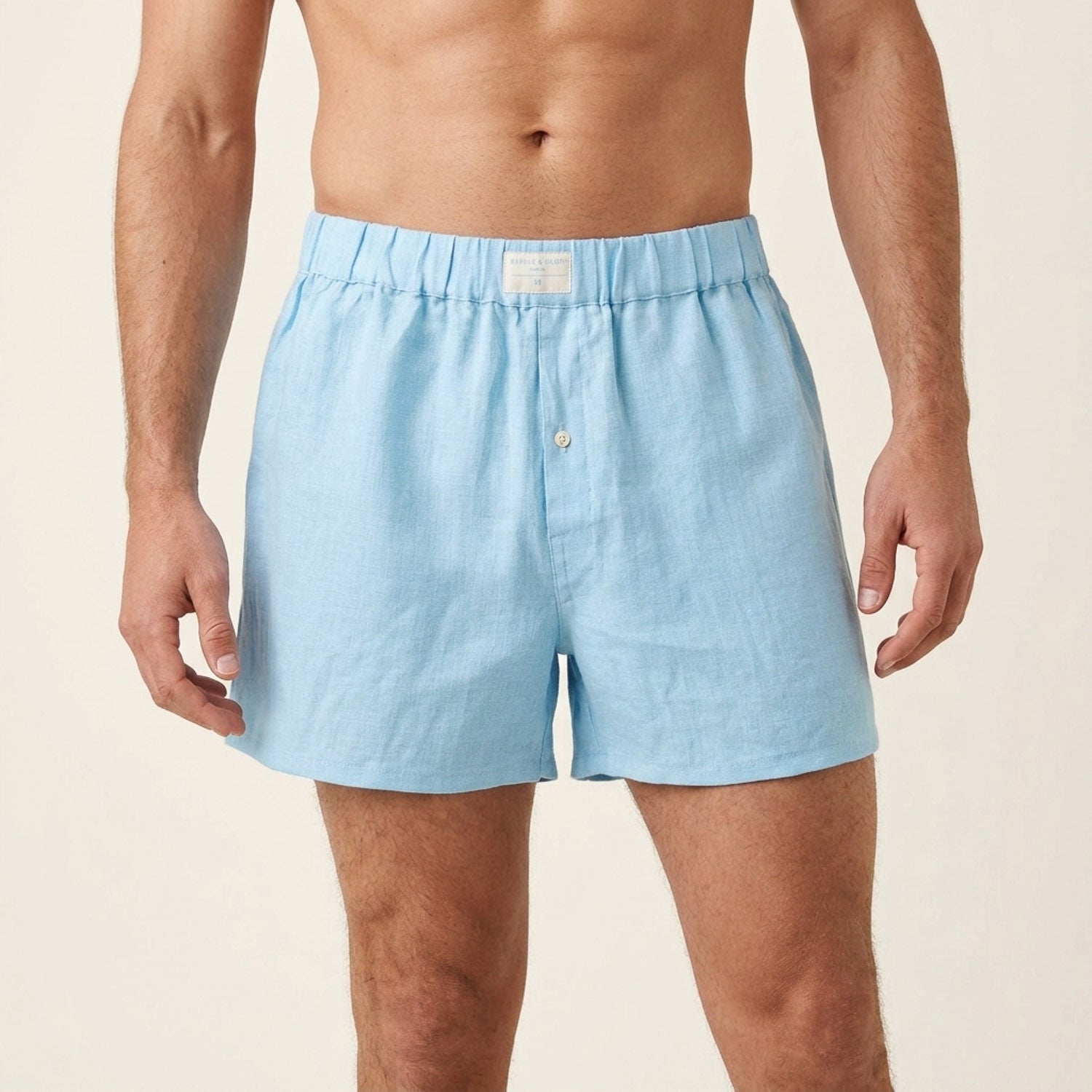A man wearing light blue boxer briefs made from soft hemp fabric, shown from the waist down against a plain off-white studio background.