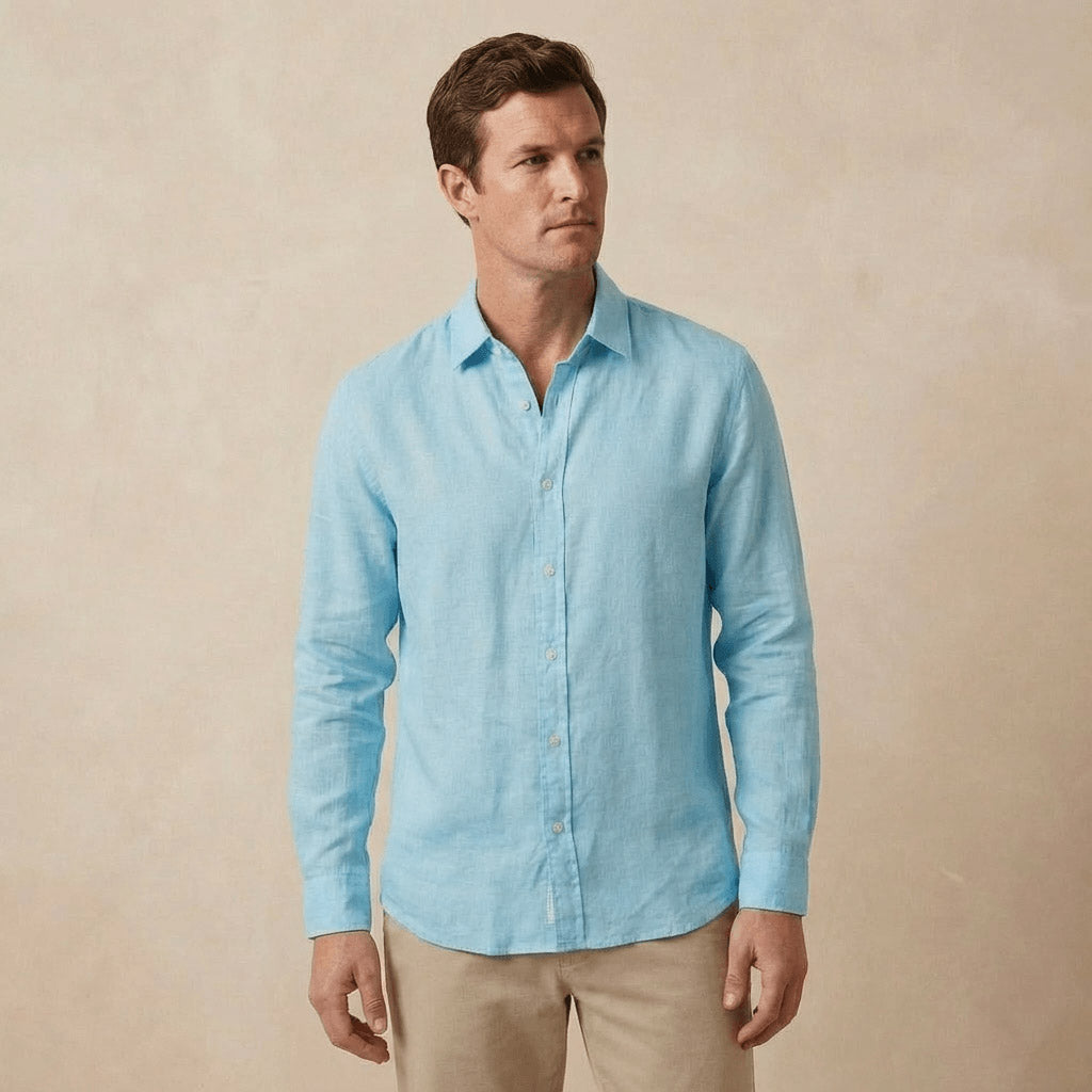 a 35 year old man models a light blue hemp shirt in front of a beige coloured backdrop