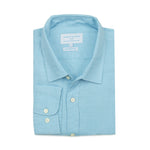 Neatly folded light blue dress shirt made from hemp fabric with a collar on a white background