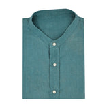 Neatly folded teal shirt made from eco-friendly hemp fabric and with small mandarin collar on a white background