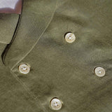 closeup of the green hemp fabric on the waistcoat and details of the buttons