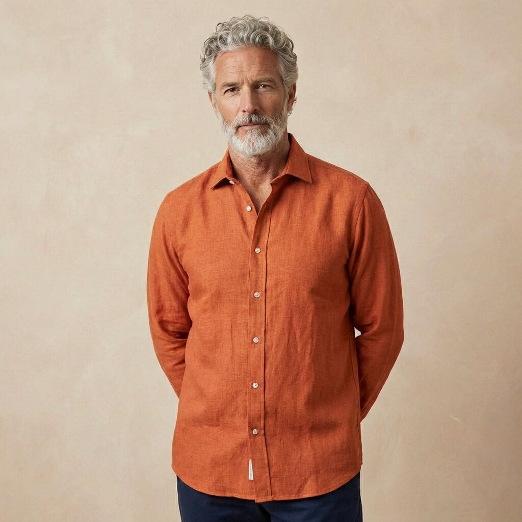 Man wearing an orange hemp shirt against a beige background