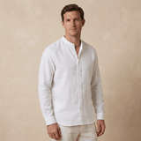 Man wearing a white hemp shirt with grandad collar against a beige background