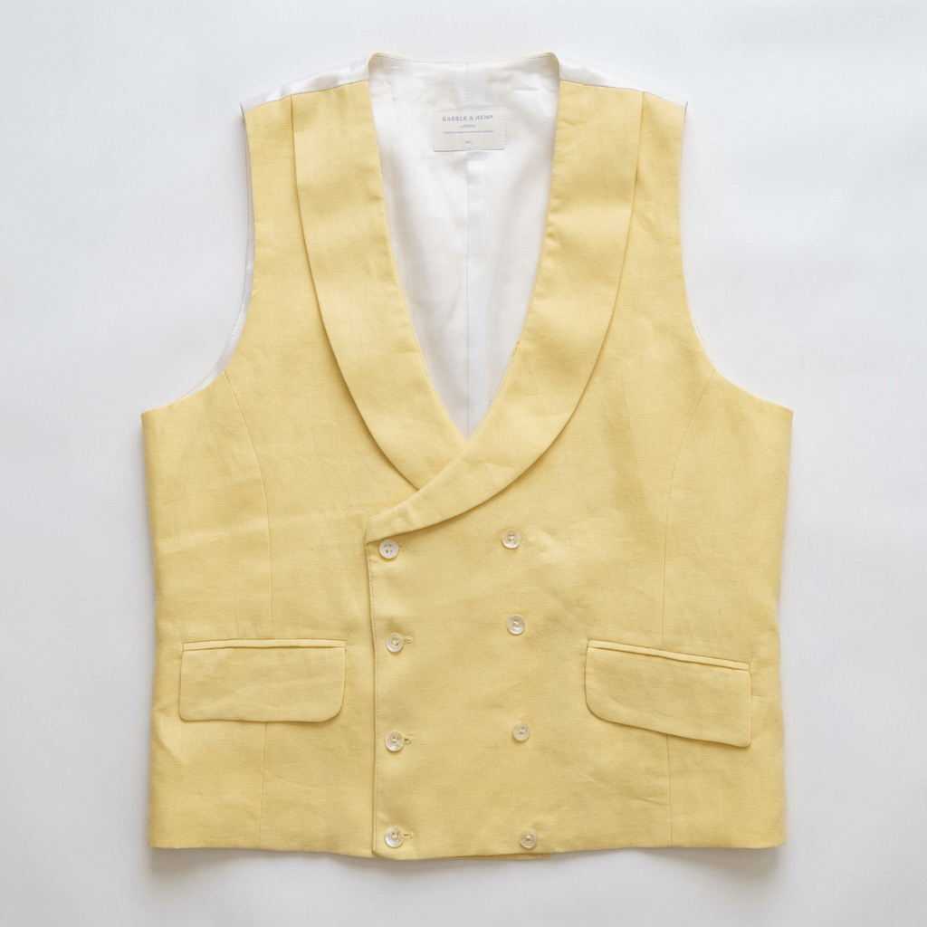 a flatlay image of a smart hemp waistcoat with double breasted buttons and shawl lapel in colour yellow