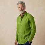 Man wearing a green hemp shirt against a beige background