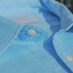 Close-up of a blue shirt collar with buttons