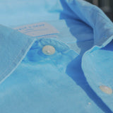 Close-up of a blue shirt collar with buttons