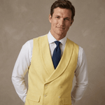 man leans to one side whilst posing at camera whilst wearing a yellow double breasted hemp wedding waistcoat