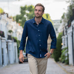 model walking whilst wearing a midnight navy blue hemp shirt