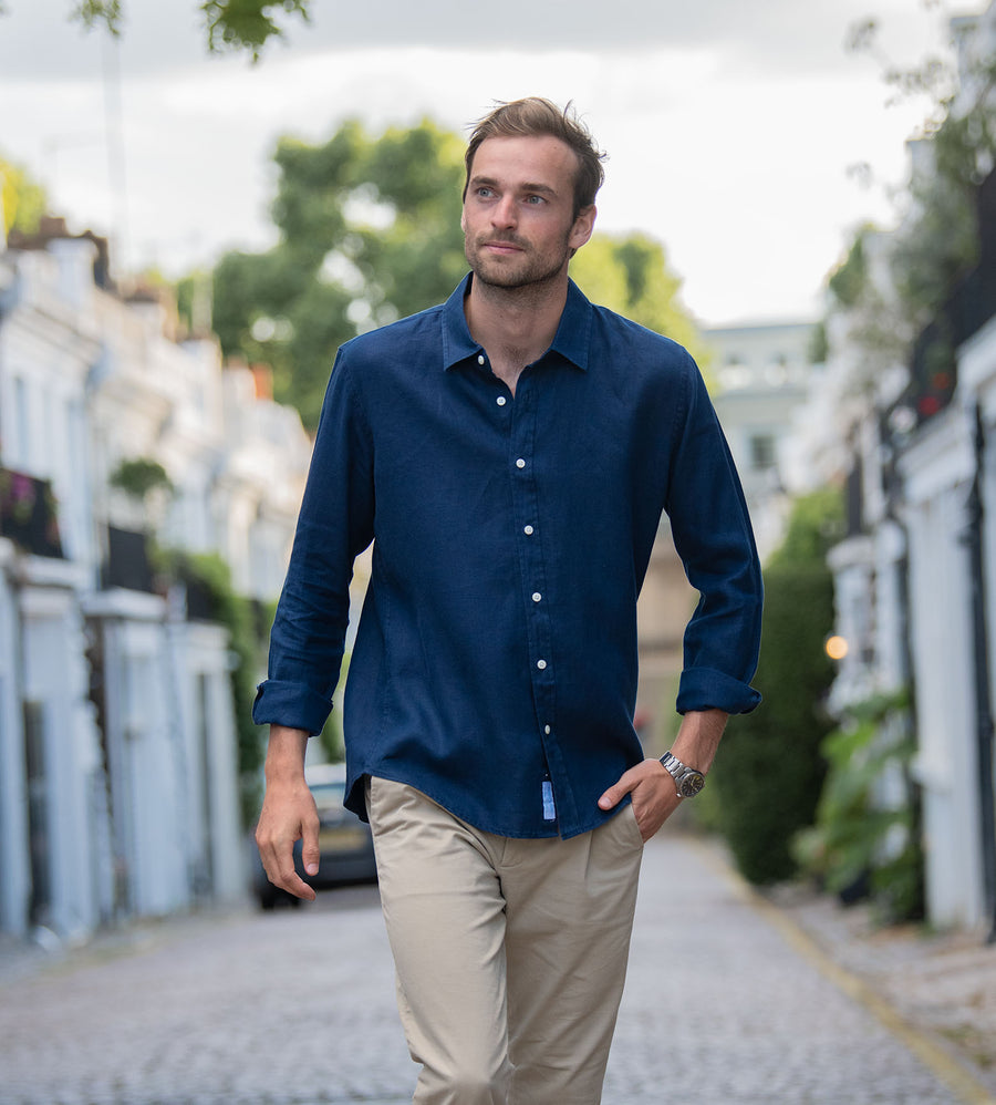 model walking whilst wearing a midnight navy blue hemp shirt