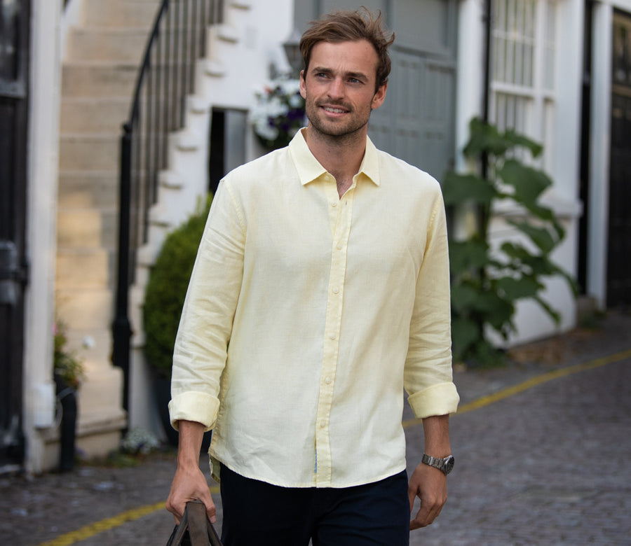 a male model wearing a yellow hemp shirt in the street